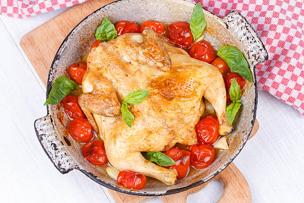 istock Roast chicken with tomatoes cherry, green basil and garlic 532091697