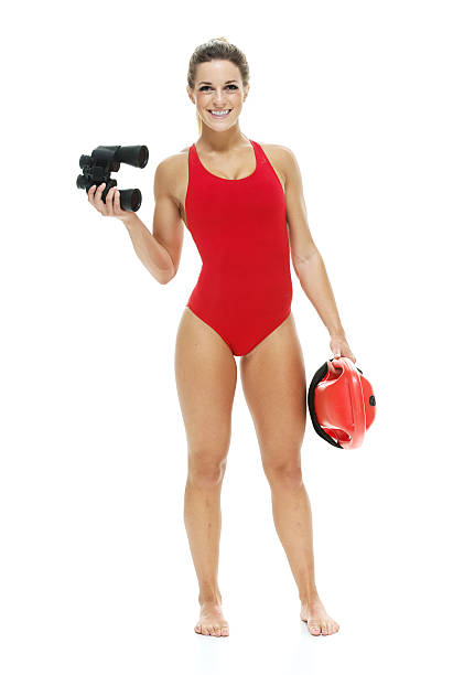 istock Female lifeguard with life buoy and binocular 532092271