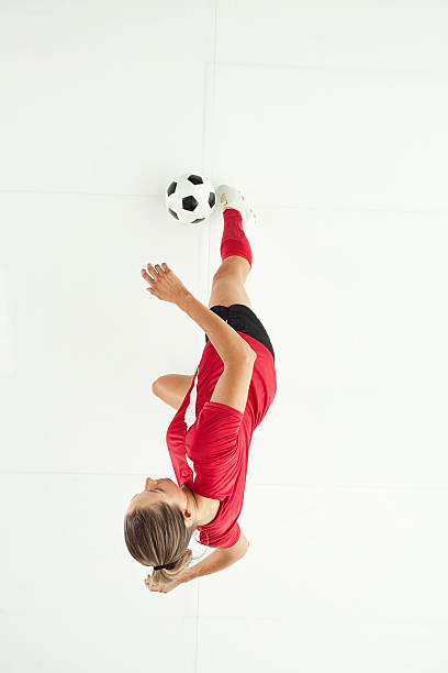 istock Female soccer player strike ball 532092273