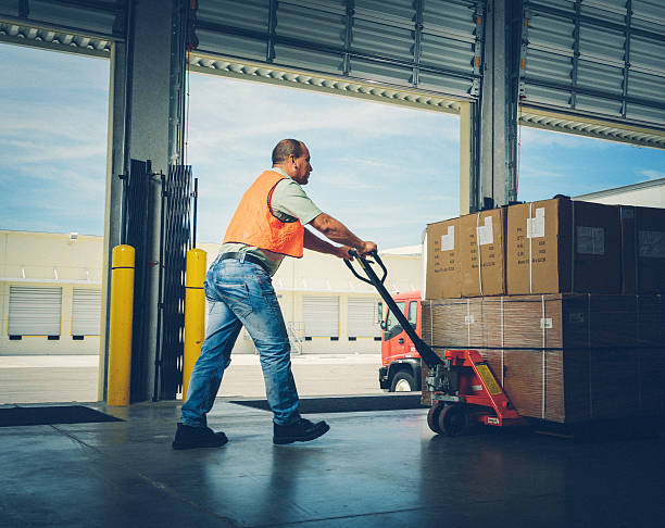istock worker with hand pallet truck 532094083