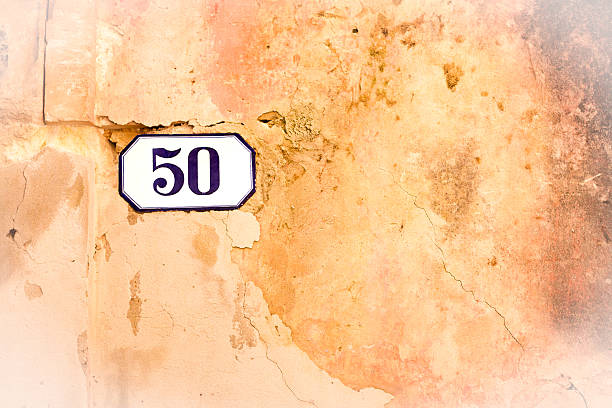 istock Number 50 Street Address Tile On Aged Mottled Orange Wall 532106528