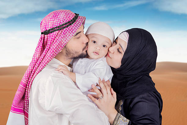 istock Arabic young couple kiss their son 532106618