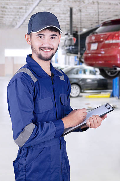 istock Asian mechanic with clipboard in workshop 532106758