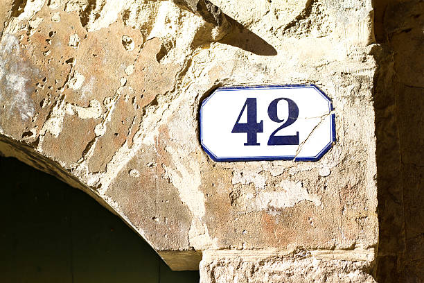 istock Number 42 Vintage Street Address Tile On Old Stone Arch 532107768