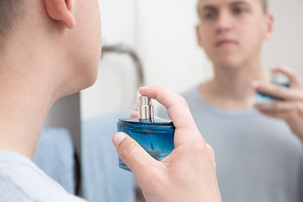istock handsome man applying parfume in bathroom 532108322