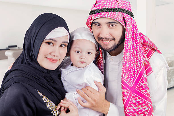 istock Arabic family smiling on the camera at home 532109308