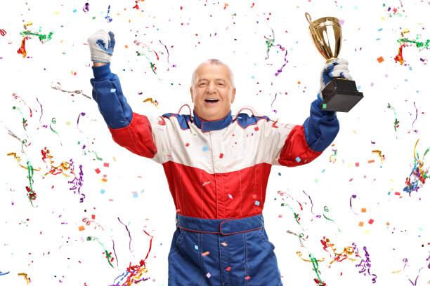 istock Mature car racing champion holding a trophy 532110340