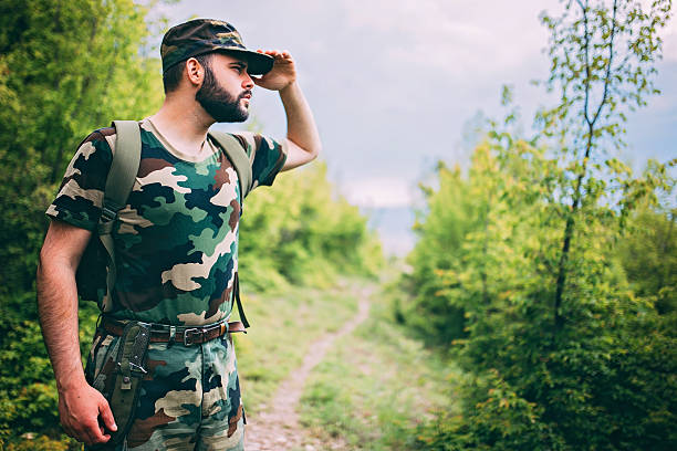 istock Young soldier or ranger wearing military uniform in forest 532110354