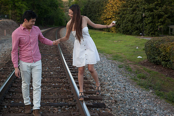 istock Couple playing on the railroad track 532112477