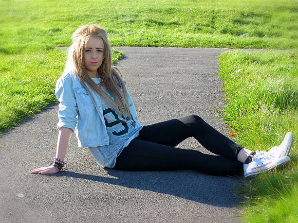istock Young Teenager sitting on a path in the park 532112791