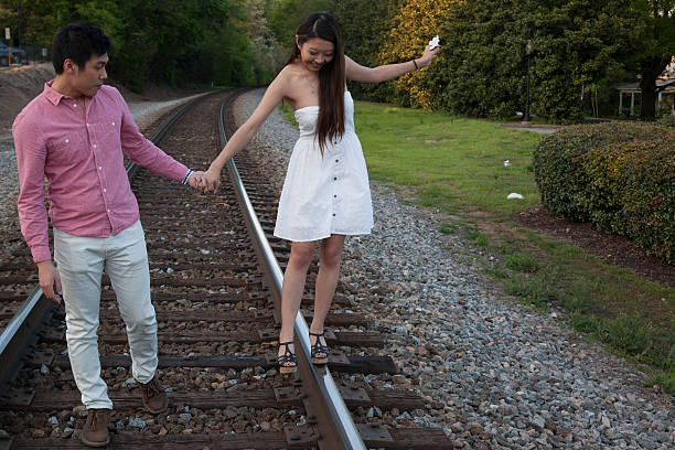 istock Couple playing on the railroad track 532113945