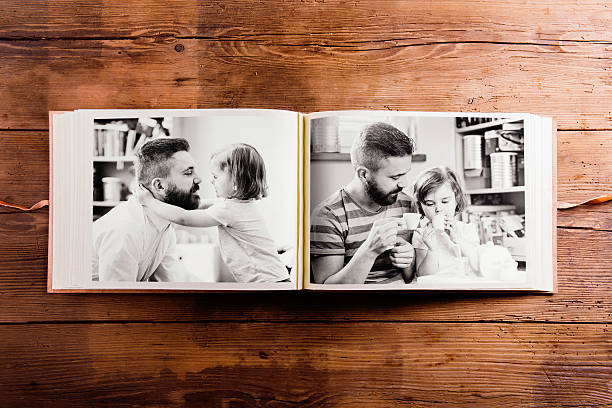 Fathers day composition. Photo album, black-and-white pictures. Fathers day composition. Photo album, black-and-white pictures. Studio shot on wooden background. scrapbook stock pictures, royalty-free photos & images