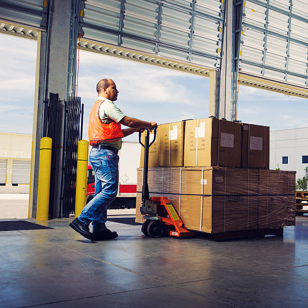 istock worker with hand pallet truck 532114499