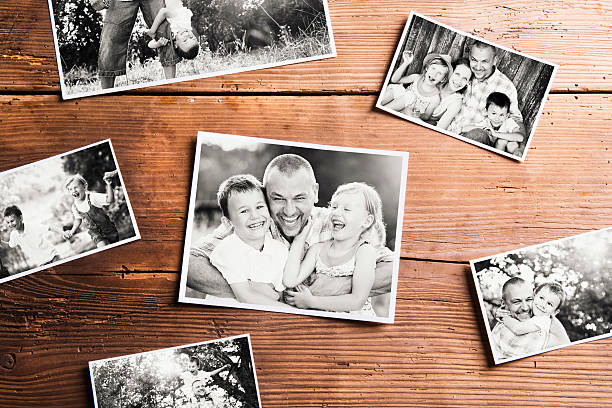 Fathers day composition. Black-and-white pictures, studio shot. Fathers day composition. Various black-and-white family pictures. Studio shot on wooden background. table photos stock pictures, royalty-free photos & images