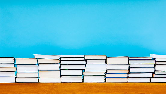 Stack of books against a blue background. Processed in AdobeRGB colorspace.