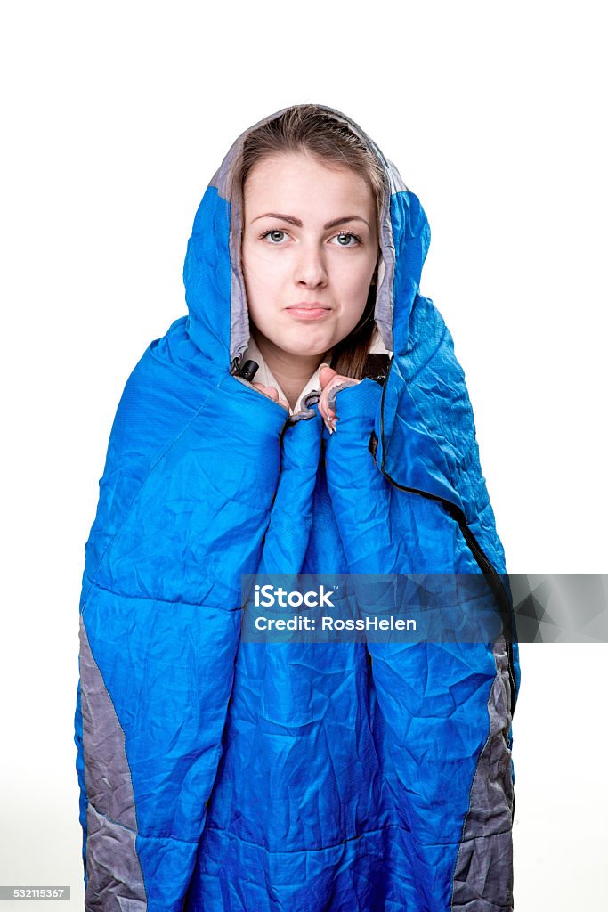 Scouts in studio Girl inside the blue sleeping bag isolated on white background One Person Stock Photo