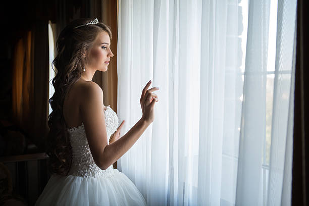 Bride looks out of the window,wedding day