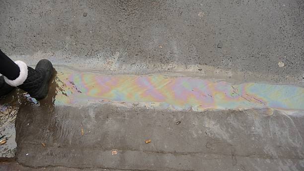 istock Oil Puddle on Ground with foot 532117741