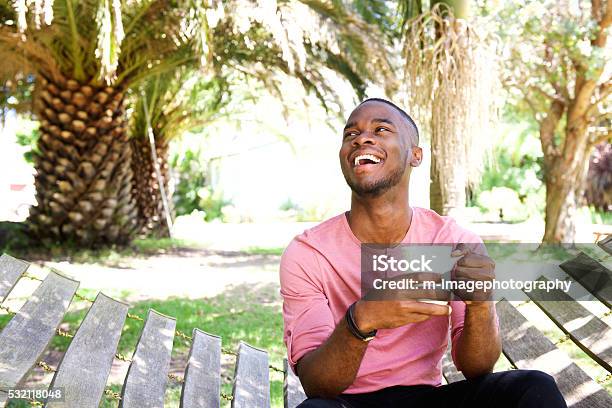 Young african man relaxing outdoors with a cup of coffee