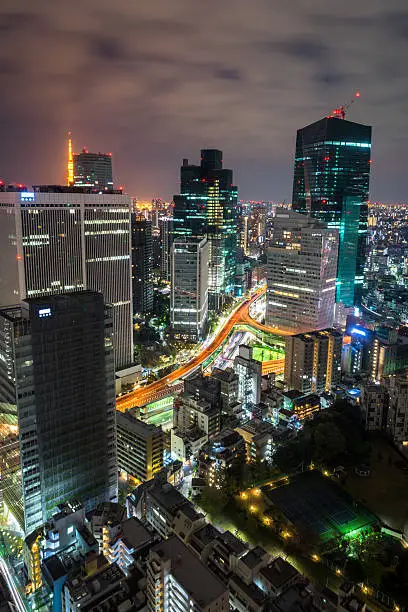 A shot from one of the high rises building in Tokyo which focuses on the illuminated expressway and the lights of the vehicleA shot from one of the high rises building in Tokyo which focuses on the illuminated expressway