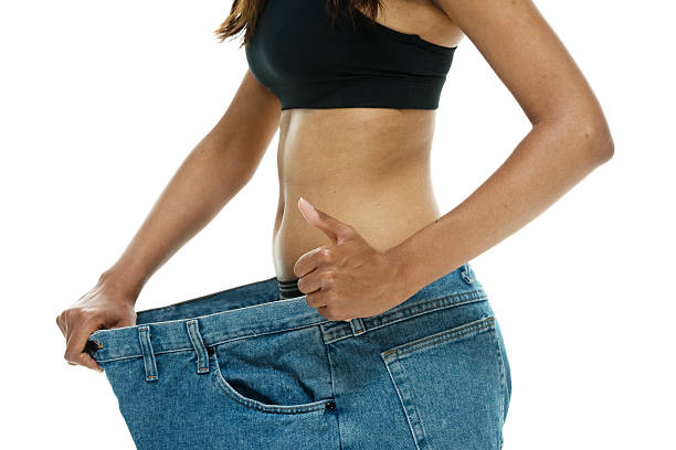 istock Woman showing off how much weight she has lost 532118887