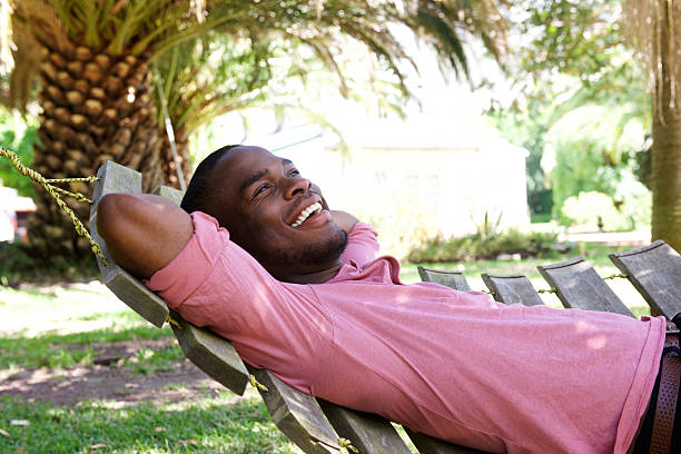 Relaxed young man lying outdoors on a hammock