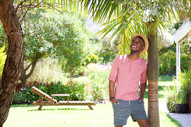African man standing outdoors on a summer day