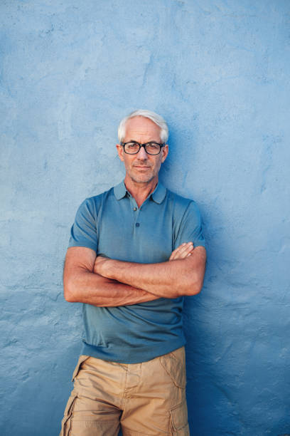istock Confident mature man standing against a blue background 532121418