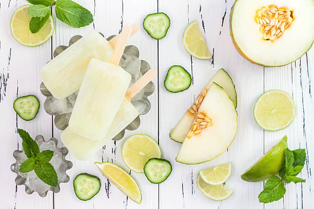 Mexican style ice pops - cucumber, lime, honeydew margarita popsicles. Refreshing mexican style ice pops - cucumber, lime, honeydew margarita paletas - popsicles. Top view,  overhead. Cinco de Mayo recipe honeydew melon stock pictures, royalty-free photos & images