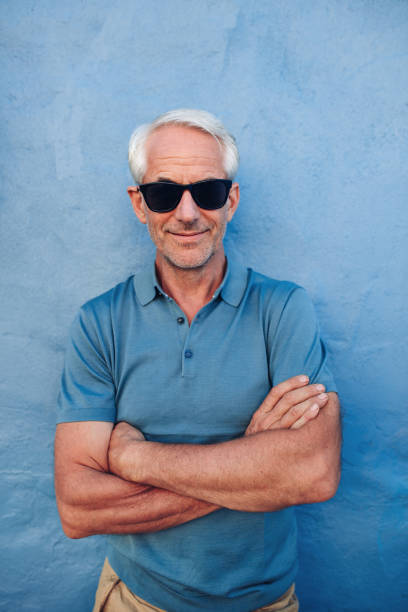 istock Handsome middle aged male posing against a blue wall 532121936