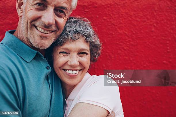 Cheerful Mature Couple Embracing Each Other Stock Photo - Download Image Now - Smiling, Couple - Relationship, Senior Couple