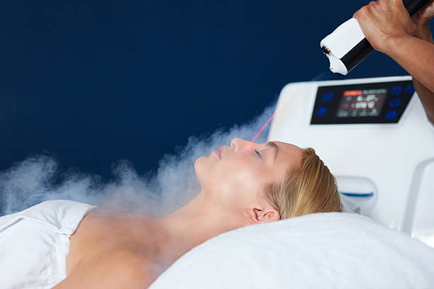 Beautiful woman getting local cryotherapy therapy Beautiful young woman getting local cryotherapy therapy in cosmetology clinic. Beautician applying cold nitrogen vapors to the face of woman. nitrogen photos stock pictures, royalty-free photos & images