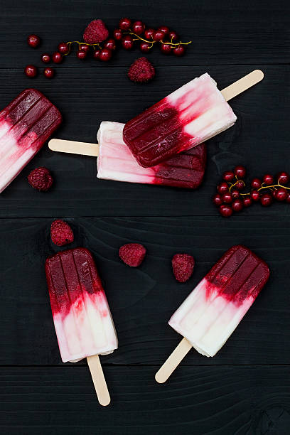 istock Berry coconut  popsicles over old black rustic wooden background 532122774