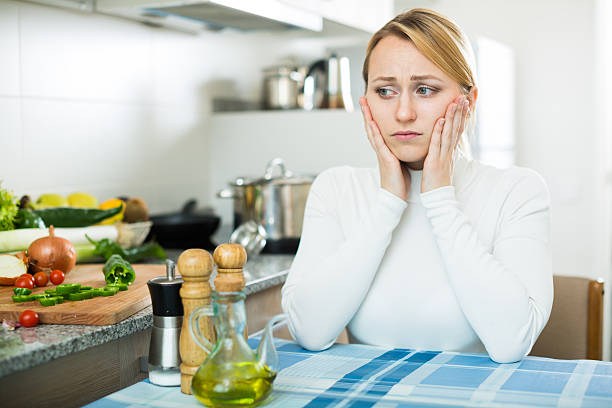 istock Miserable young woman in domestic kitchen 532123966