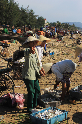 Halong Bay, Vietnam - September 5, 2015: women selling fish at the beach after fishing, Vietnam