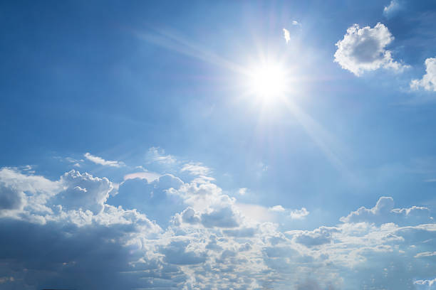 istock Rays of sun in blue sky and white clouds 532125066