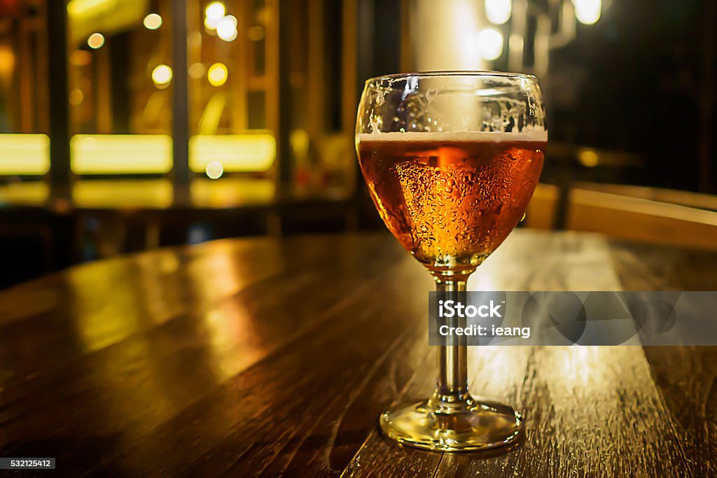 Vintage glass of light beer on a pub restaurant Alcohol - Drink Stock Photo