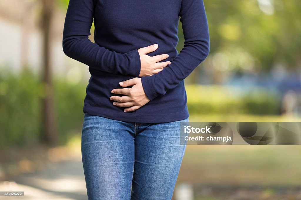 Woman Has Stomach Ache at Park Abdomen Stock Photo