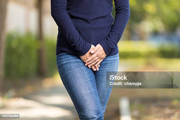 Woman With Hands Holding Her Crotch Stock Photo - Download Image Now - Urinating, Urine, Women