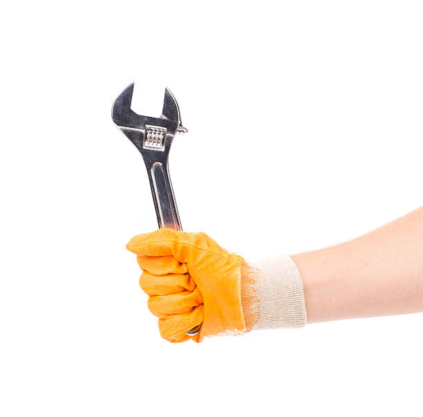 istock Hand in gloves holding wrench. 532126452