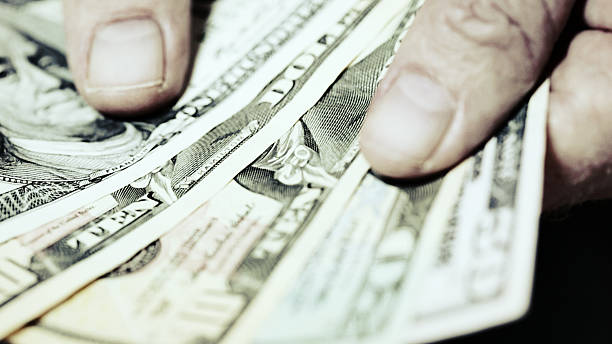 istock Hands fan out sheaf  of American banknotes 532127244
