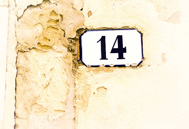 istock Number 14 Street Address Tile On Old Pale Yellow Wall 532128228