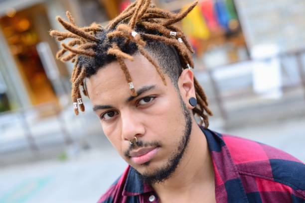 Cool young man A young man with lots of tattoos and piercings. septum piercing stock pictures, royalty-free photos & images