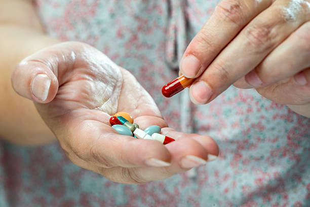 istock Older women with medicine into hand. 532129328