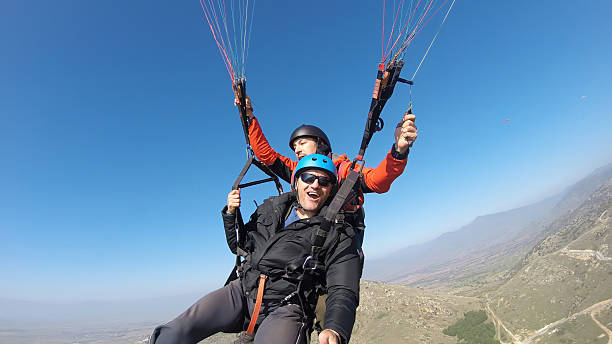 istock Tourist playing paragliding guided by a pilot 532130069