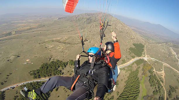 istock Tourist playing paragliding guided by a pilot 532130085