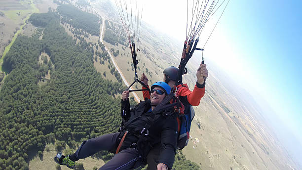 istock Tourist playing paragliding guided by a pilot 532130091