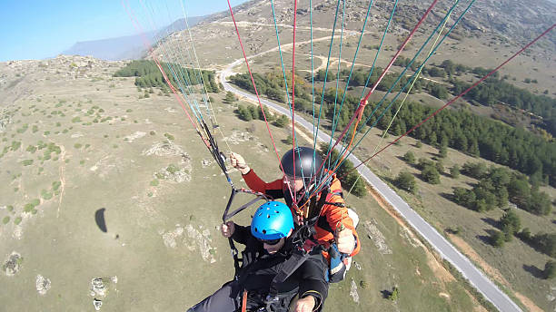 istock Tourist playing paragliding guided by a pilot 532130095
