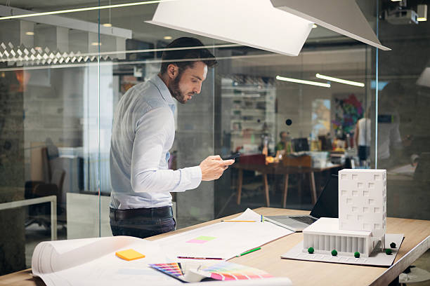 istock Designer typing on smart phone in office. 532131387