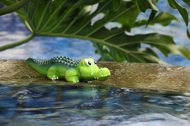 istock Toy croaky by the pool with flowing water 532131407